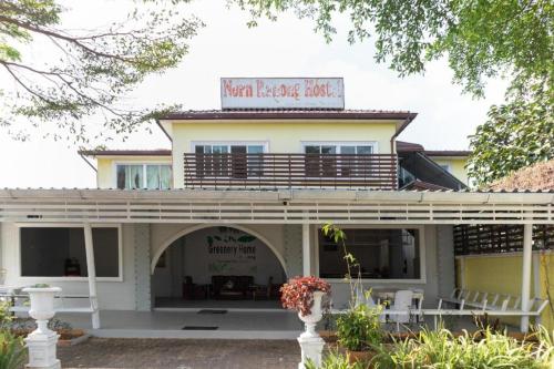 a building with a sign on top of it at OYO 674 Greenery Home in Ranong
