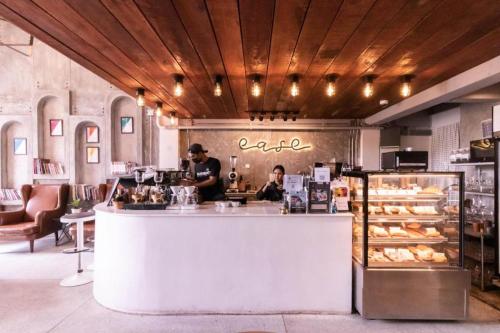 two people standing at a counter in a bakery at The Singha Hotel - Korat in Nakhon Ratchasima