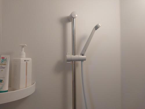 a toothbrush holder in a bathroom next to a mirror at 自炊の出来るキッチン付きの貸切宿-Joyjoy奄美 in Setouchi