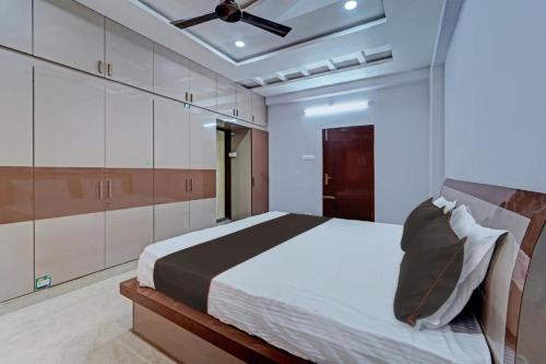a bedroom with a bed and a ceiling fan at Vaga Suites in Tirupati