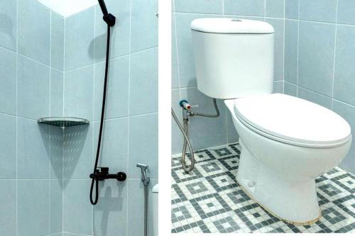 a bathroom with a white toilet in a shower at Capital O 92804 La Tansa Syariah Hotel in Bekasi
