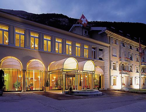a hotel room with a large window overlooking a city at Thermal Hotels & Walliser Alpentherme Leukerbad in Leukerbad