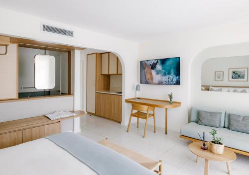 a bedroom with a bed and a desk and a table at The Surf Yamba in Yamba
