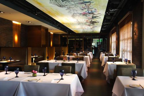 a row of tables in a restaurant with white linens at Grand Victoria Hotel in Taipei