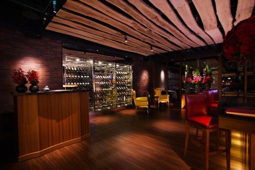 a restaurant with a bar with a bunch of wine bottles at Grand Victoria Hotel in Taipei