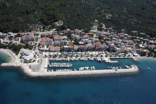 an aerial view of a resort with a harbor at Hotel Laurentum in Tučepi