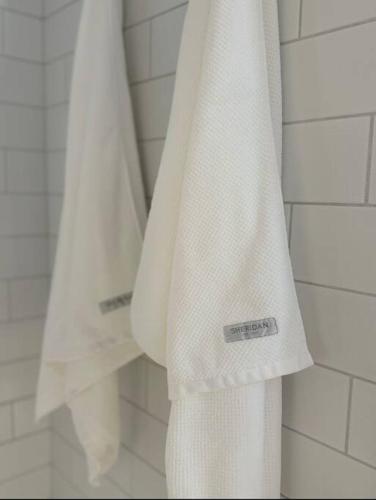 a white towel is hanging in a bathroom at The Warra House in Dubbo