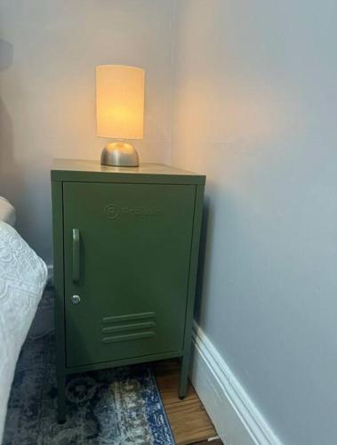a green cabinet with a lamp on top of it at The Warra House in Dubbo
