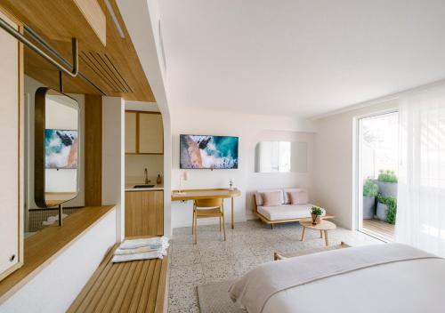 a bedroom with a bed and a living room at The Surf Yamba in Yamba