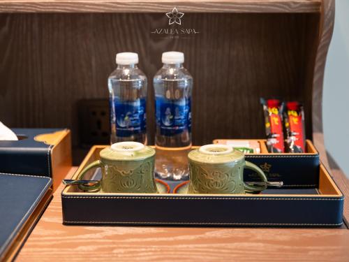 two bottles of water sitting on top of a table at Azalea Sapa Hotel in Sa Pa