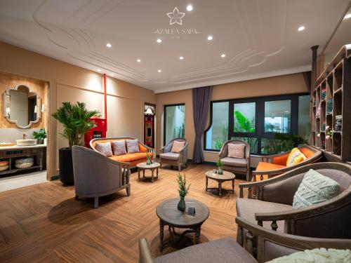 a living room with couches and chairs at Azalea Sapa Hotel in Sa Pa