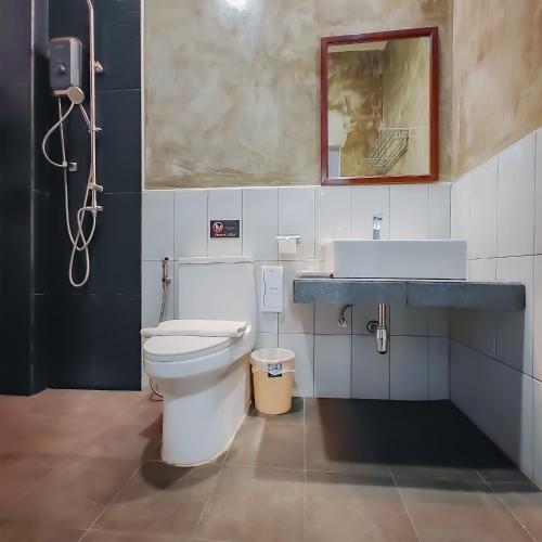 a bathroom with a toilet and a sink at The Riva Vientiane Hotel in Vientiane
