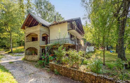 a large house with a balcony and trees at Nice Apartment In Ledenice With Wifi in Ledenice