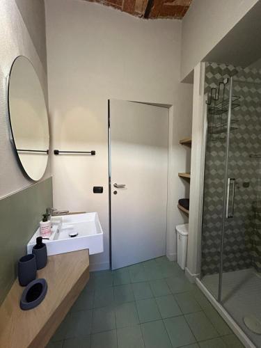 a bathroom with a sink and a shower at Civico 11 in Alba