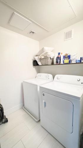 a laundry room with a washer and dryer at Rest Away in Las Vegas