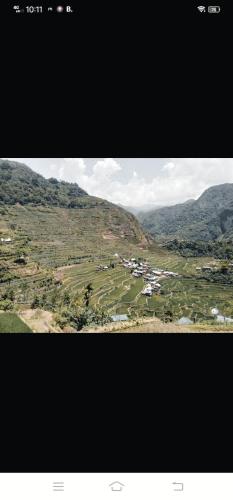 a view of a valley with houses on a mountain at Batad Village Homestay & Restaurant in Banaue