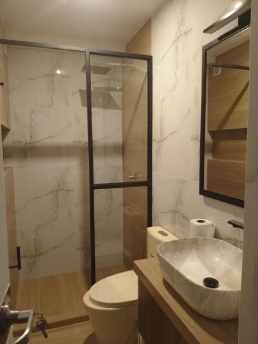 a bathroom with a sink and a toilet and a shower at Suites Plaza Burgos in Chachapoyas