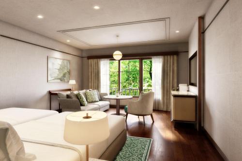 a hotel room with a bed and a living room at Mampei Hotel in Karuizawa