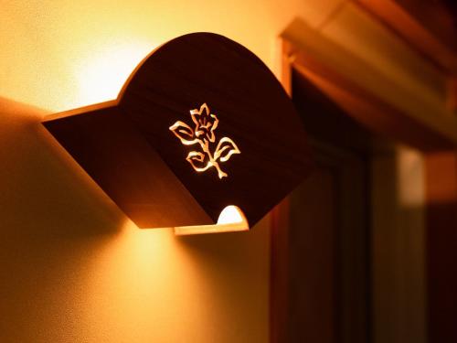 a light with a heart on a wall at Otowaya Ryokan in Yuzawa