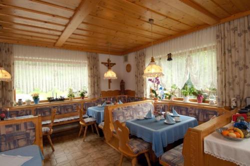 a dining room with two tables in a restaurant at Pension Jägerhof in Mallnitz