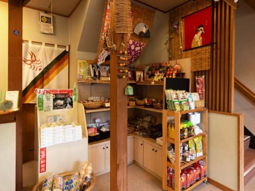 a room with a counter and shelves with food at Otowaya Ryokan in Yuzawa