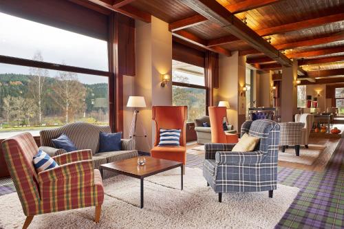 a living room with couches and chairs and a table at Cihelny Golf & Wellness Resort in Karlovy Vary