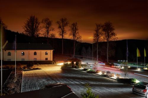 a city street at night with a building and cars at Cihelny Golf & Wellness Resort in Karlovy Vary