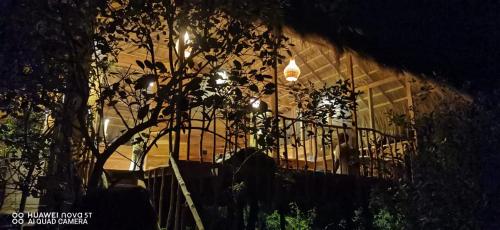 a house with a staircase in front of a fence at Mamba Yala in Tissamaharama