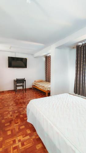 Postel nebo postele na pokoji v ubytování CASA RICARDO PALMA con PISCINA