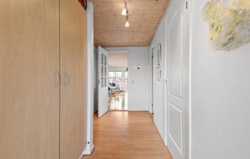 a hallway with white walls and a wooden ceiling at Holiday Home Fanø 59 in Fanø