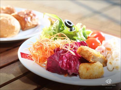 a white plate of food with salad and cheese at Daiwa Roynet Hotel Matsuyama in Matsuyama