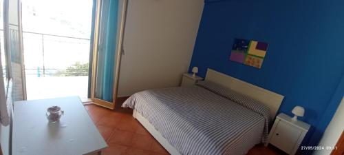 una piccola camera da letto con un letto e un tavolo di La Casa Gialla a Trabia