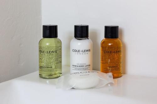 three bottles of essential oils sitting on a shelf at Beechwood House in Melton Mowbray