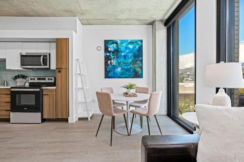 a kitchen and living room with a table and chairs at Downtown views! Amazing pool gym hottub Luxury apt in Salt Lake City