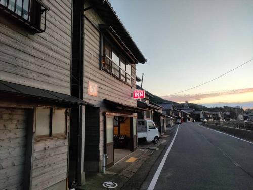 an empty street in a town with a building at INN Sodeshi 丹後 一棟貸し 海の宿 INN袖志 in Kyotango