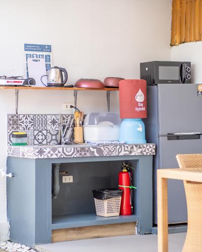 a kitchen with a sink and a refrigerator at Bali Villas Panglao Bohol in Panglao