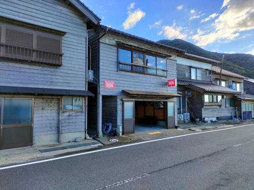 a row of buildings on the side of a street at INN Sodeshi 丹後 一棟貸し 海の宿 INN袖志 in Kyotango