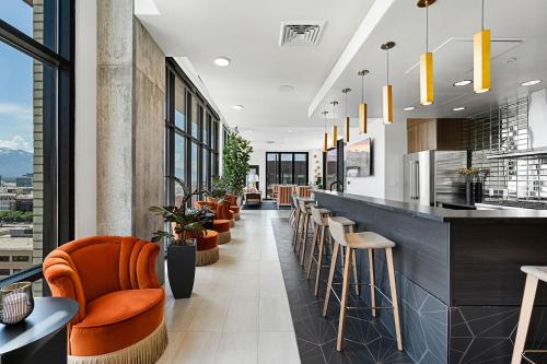 a restaurant with a bar with orange chairs at Downtown views! Amazing pool gym hottub Luxury apt in Salt Lake City