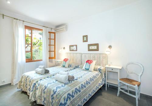 a bedroom with a bed with stuffed animals on it at Can Menonge by Vintage Travel in Pollença
