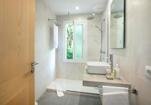a bathroom with a sink and a mirror at Can Menonge by Vintage Travel in Pollença