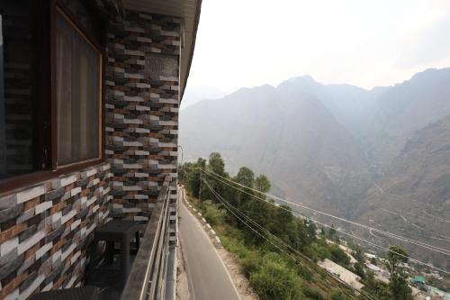 a room with a view of a mountain view at Sleeping Beauty Hotel Moutain view property in Joshīmath