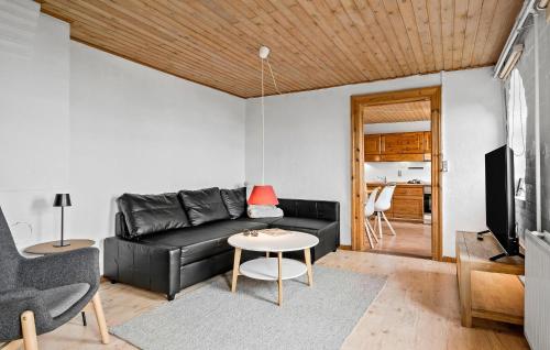 a living room with a black couch and a table at Nice Apartment In Egernsund With Wifi in Egernsund