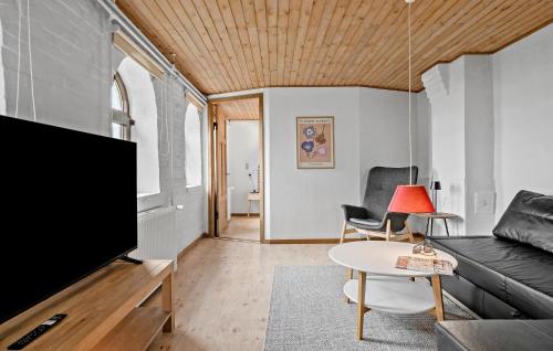 a living room with a couch and a tv at Nice Apartment In Egernsund With Wifi in Egernsund