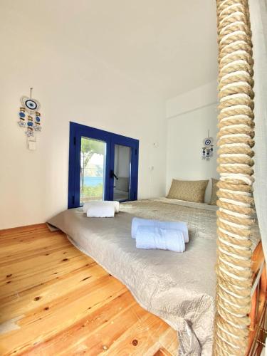 a bedroom with two beds and a wooden floor at Emborios Views - Holiday House in Kalymnos