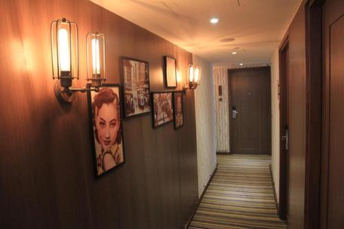 a hallway with pictures on the walls of a hotel at Largos Hotel in Hong Kong