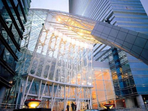 a large glass building with lights in a city at Kai Wah Plaza International Hotel in Kunming