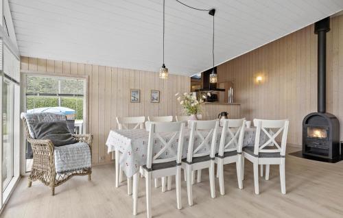 a dining room with a table and chairs and a fireplace at Holiday Home Thorsvej Otterup V in Otterup