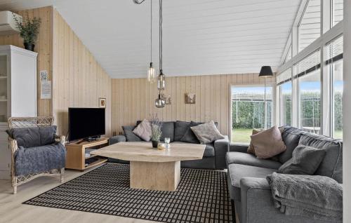 a living room with a couch and a table at Holiday Home Thorsvej Otterup V in Hasmark