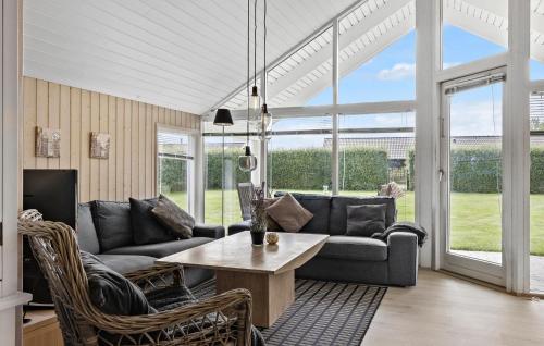a living room with a couch and a table at Holiday Home Thorsvej Otterup V in Otterup