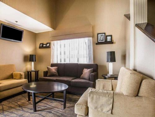 a living room with a couch and a table at Sleep Inn Bessemer Helena in Bessemer
